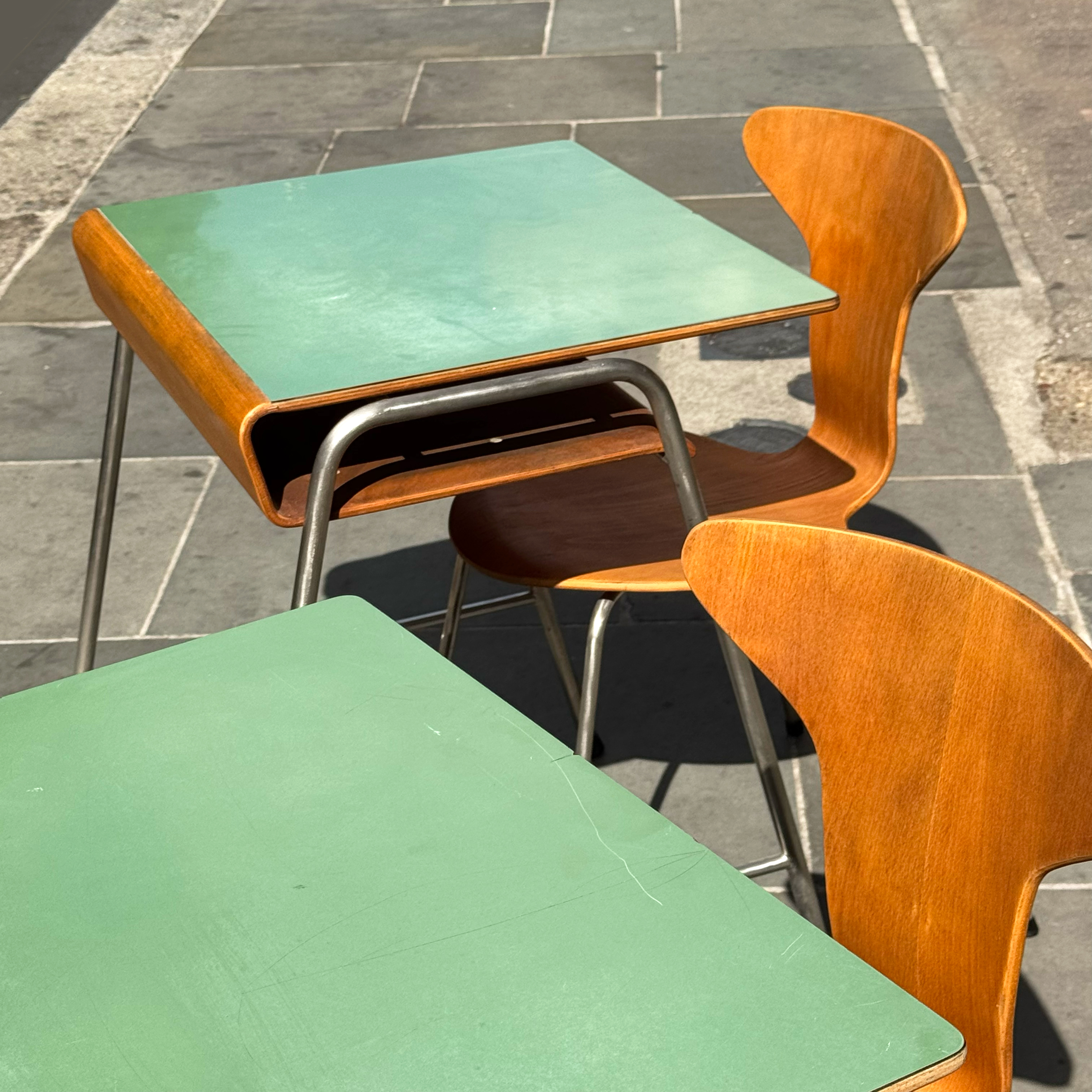 School desks and chairs by Arne Jacobsen, with green desk tops and wood veneer details