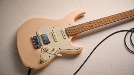 A Cort G200SE on a dirty white floor