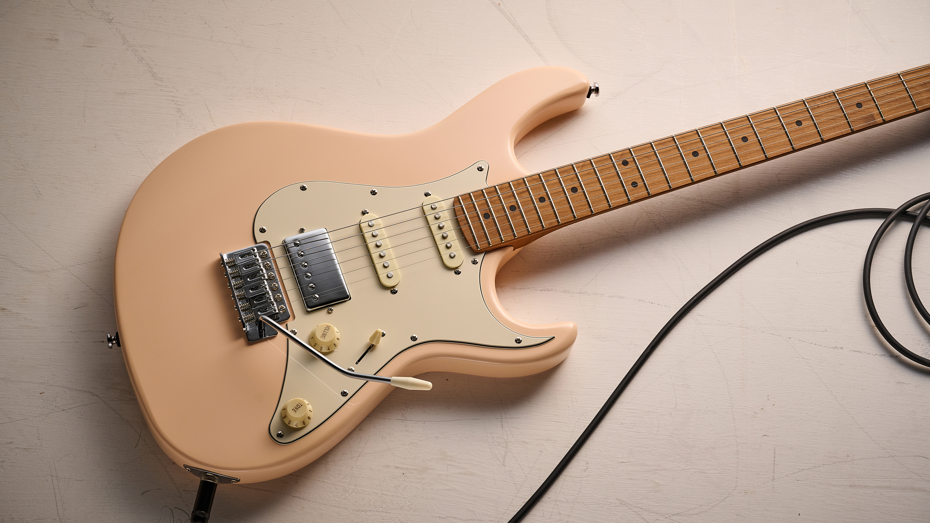 A Cort G200SE on a dirty white floor