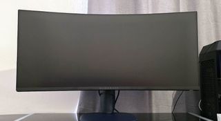 The Alienware A3425DWM monitor on a glass desk