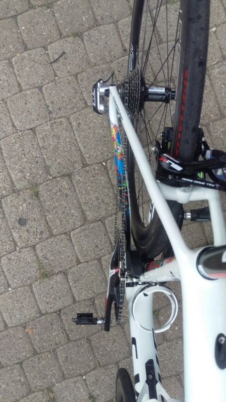 The silver and black rear derailleur.