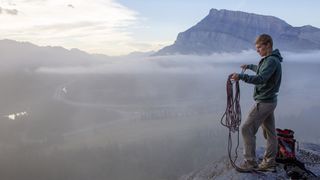 how to store climbing rope: climber managing rope