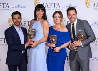 Neet Mohan, Kirsty Mitchell, Elinor Lawless and Michael Stevenson pose with the Soap Award for 'Casualty' in the Winners Room during the 2024 BAFTA Television Awards.