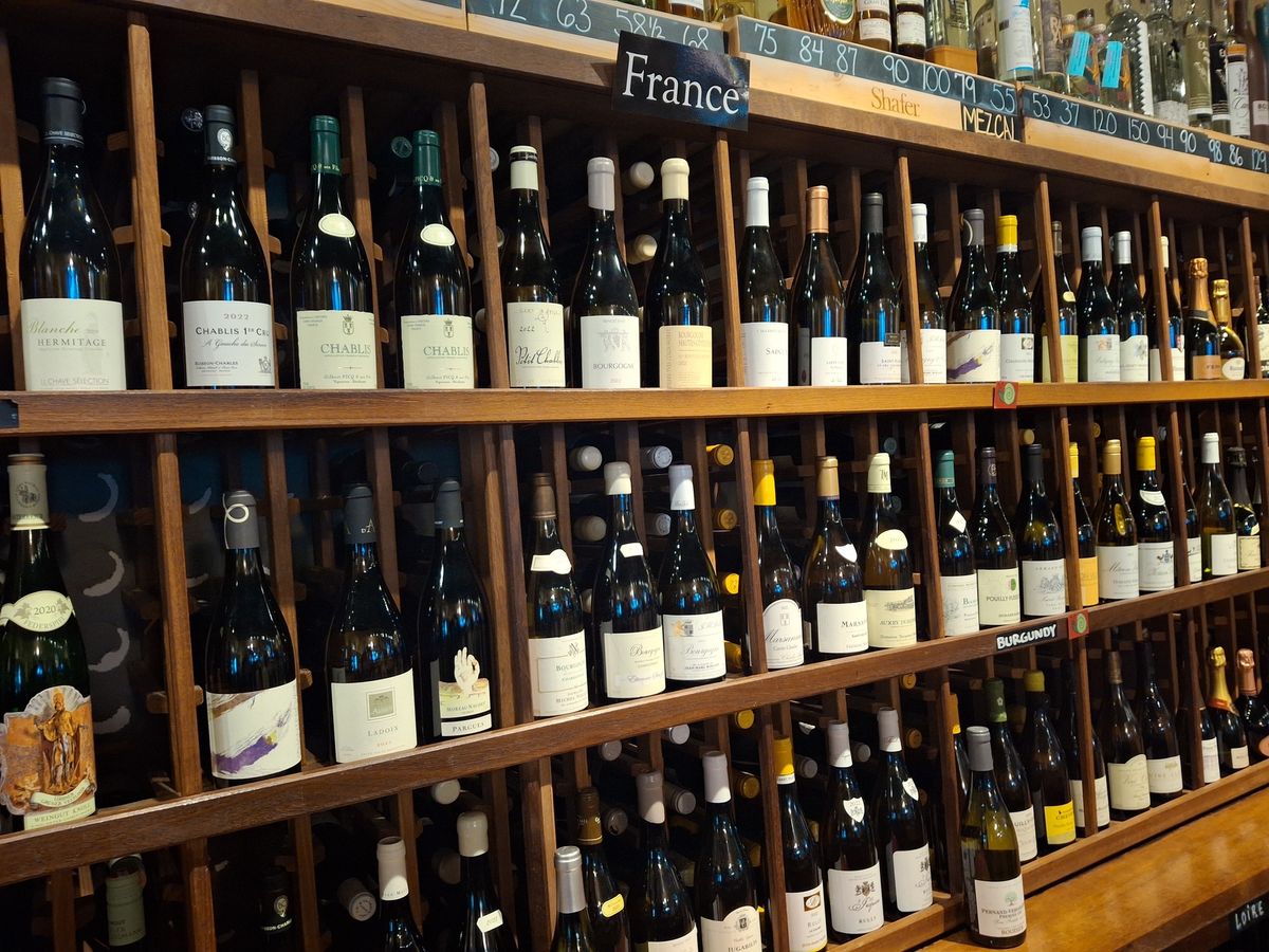 Multiple shelves of wine bottles in store shot by Galaxy A35