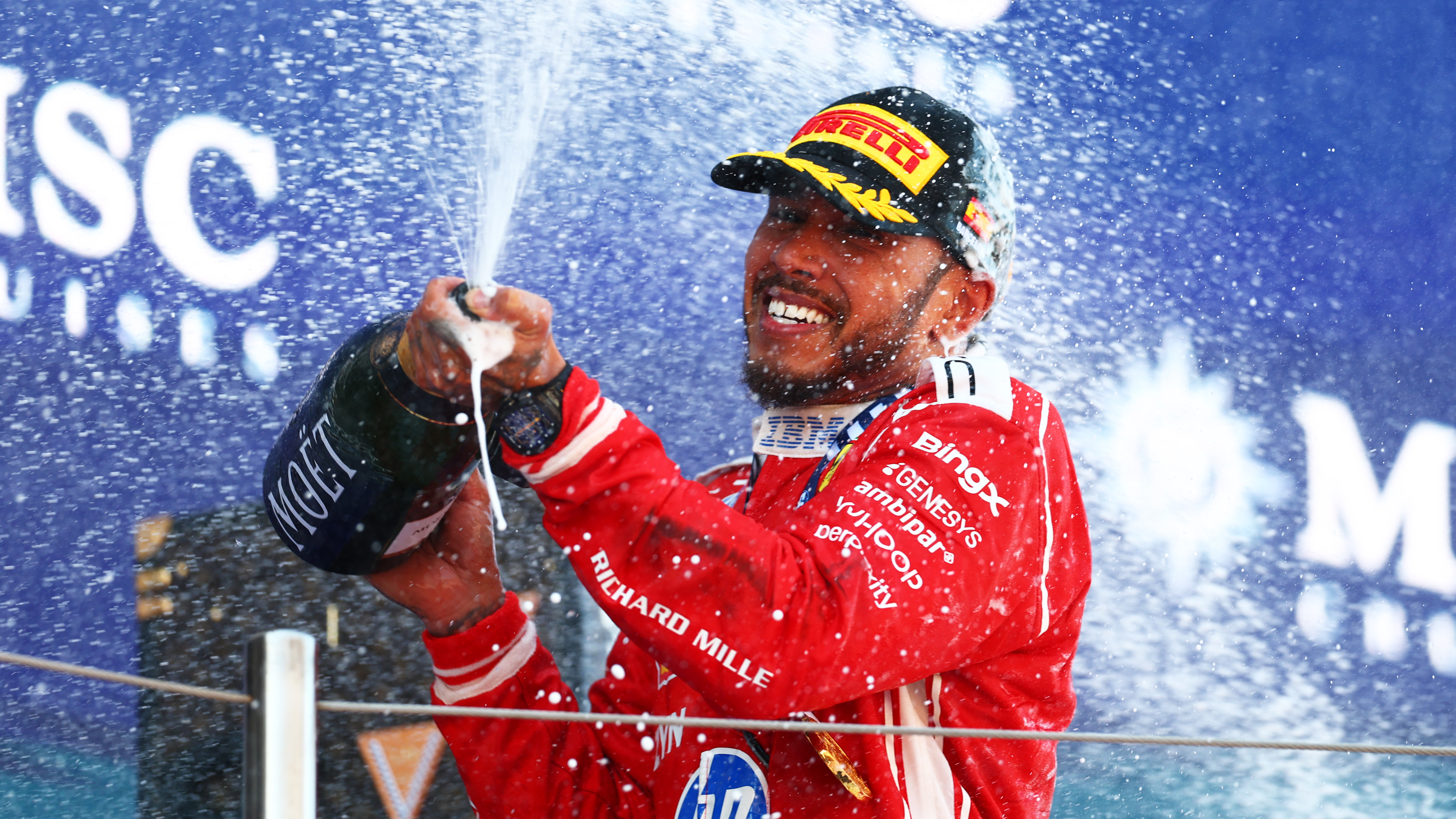 Race winner Lewis Hamilton of Great Britain and Scuderia Ferrari celebrates on the podium with Champagne during the F1 Grand Prix of Barcelona-Catalunya