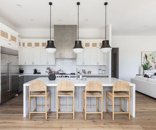 White kitchen with stone countertops on the island