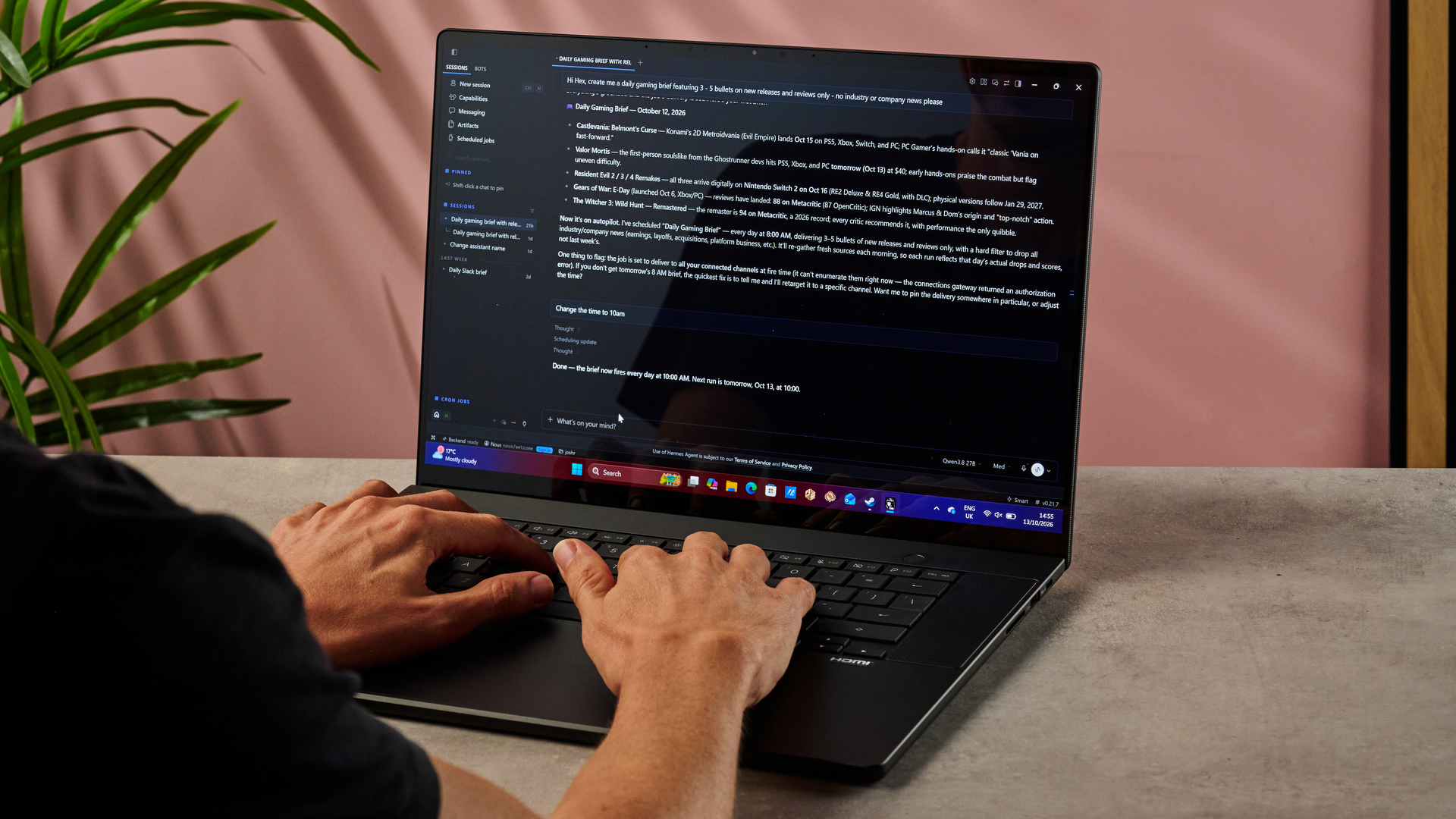 A man types into the Hermes hybrid AI agent app on the Asus ProArt P16 RTX Spark laptop.