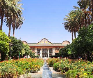 Paradise garden with central water channel and colorful borders