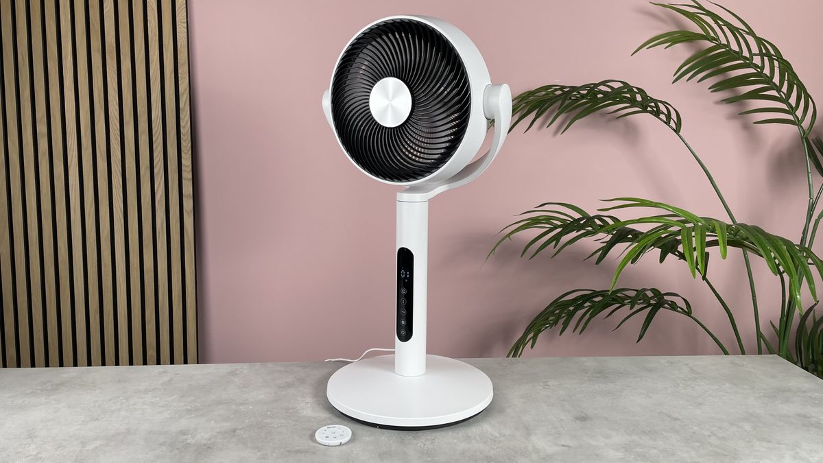 The Levoit CirculAir is in its tabletop format on a desk in a pink living room.