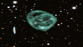 Data from SARAO's MeerKAT radio telescope data (green) showing the odd radio circles, is overlaid on optical and near infra-red data from the Dark Energy Survey.