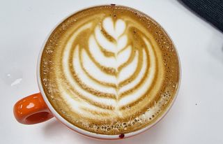 latte art in an orange mug