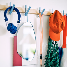 IKEA PS Rack with 5 hooks holding headphones, mirro, whistle and cap.