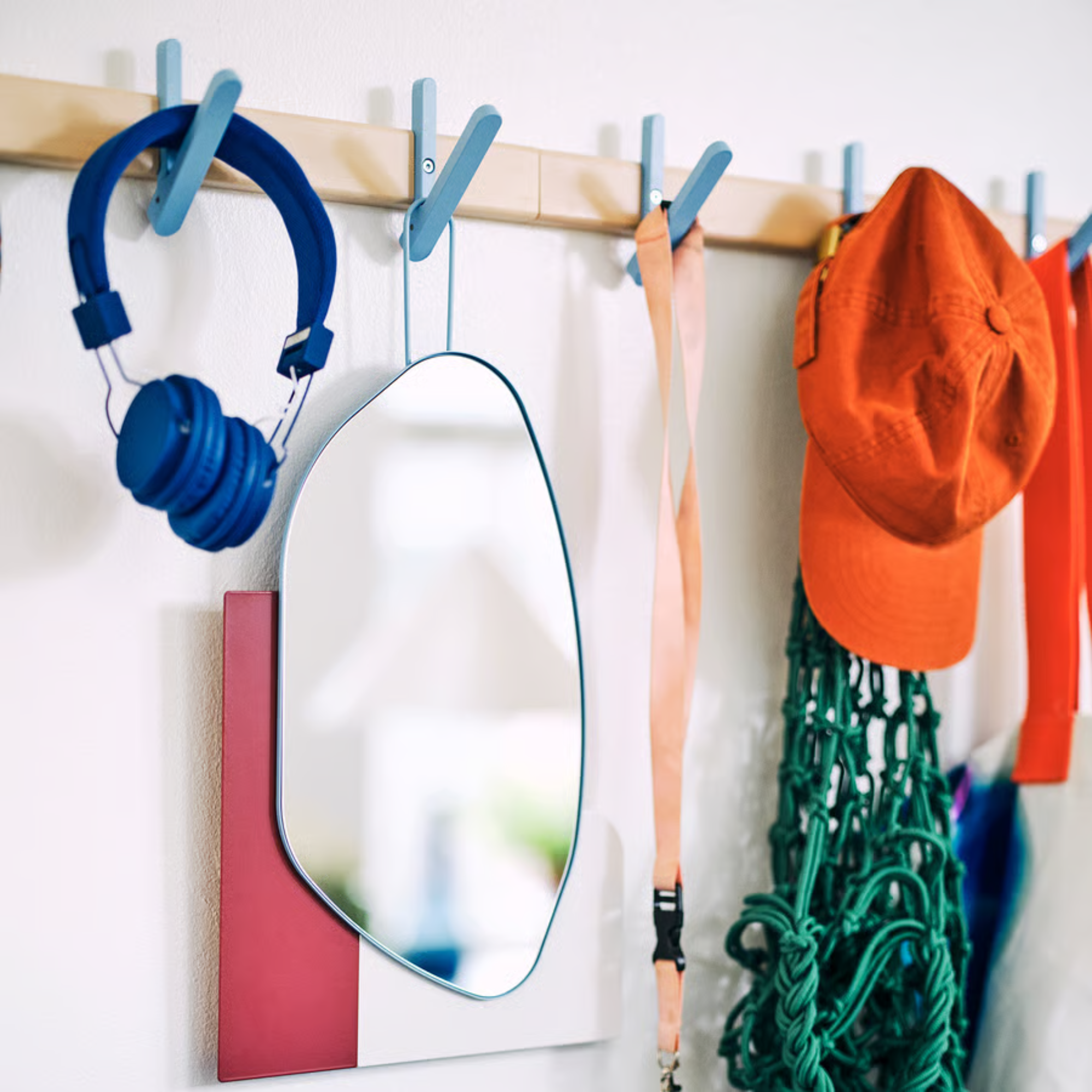 IKEA PS Rack with 5 hooks holding headphones, mirro, whistle and cap.