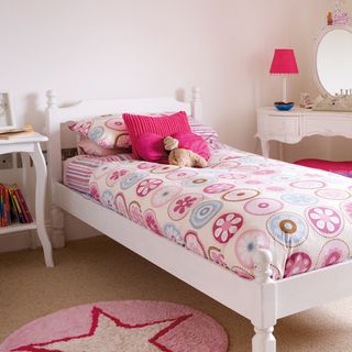 child bedroom with pink bedlinen and pink lamp