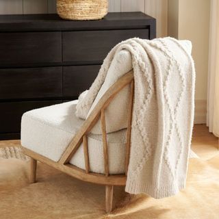 Diamond Cable Knit Throw on a chair. 