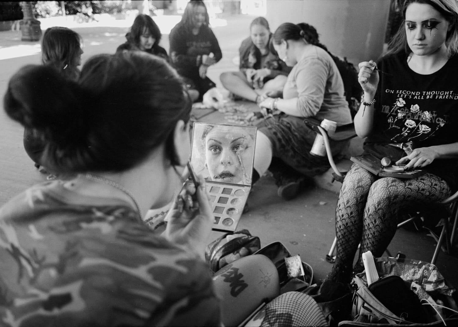 Punk fans painting their faces.