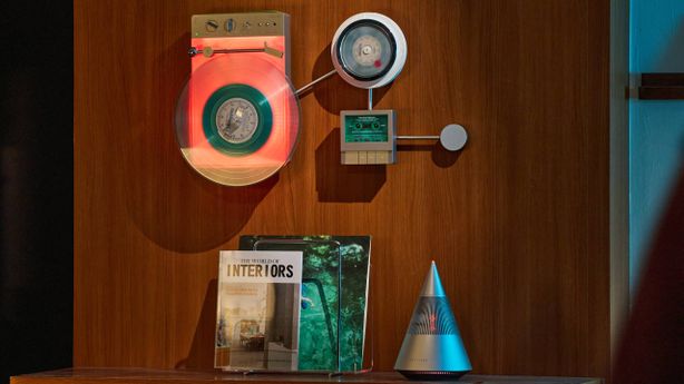 The Trettitre Retro Ambient Audio System on a wall, above the brands speaker.