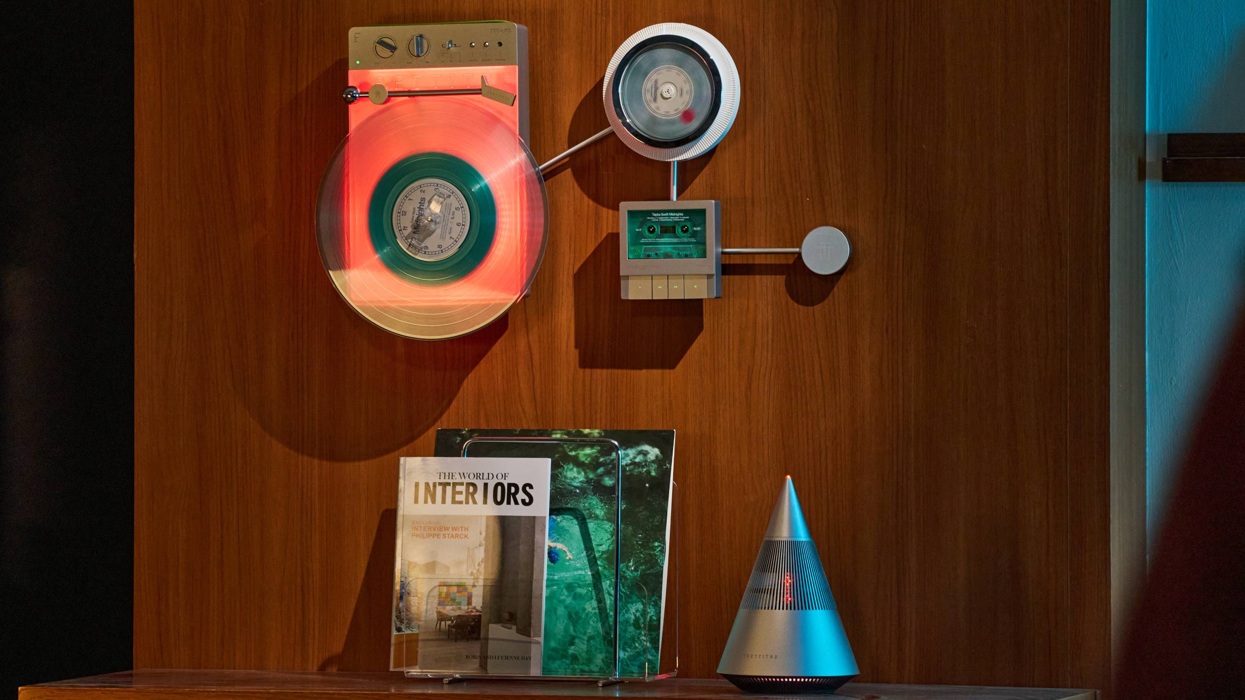 The Trettitre Retro Ambient Audio System on a wall, above the brand's speaker.