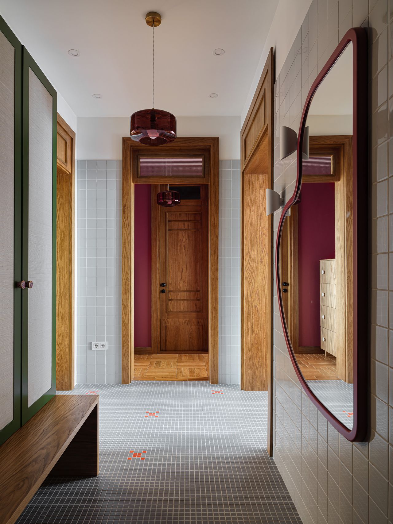 A passageway in an apartment with tiled flooring and walls