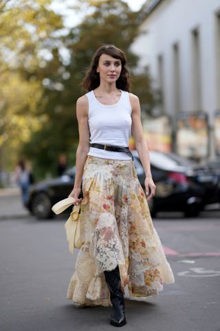 woman in tank top and floral skirt