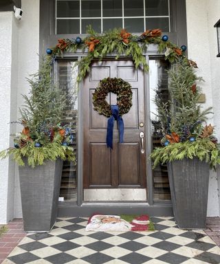 Two large festive planters flanking a front door