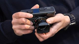 The Pixii Max camera being held in two hands
