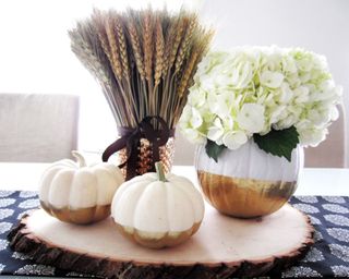 Trio of white pumpkins including DIY pumpkin vase ideas on wooden coaster