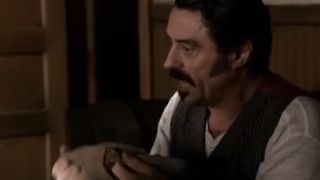 Ian McShane with a mustache, looking angry on Deadwood