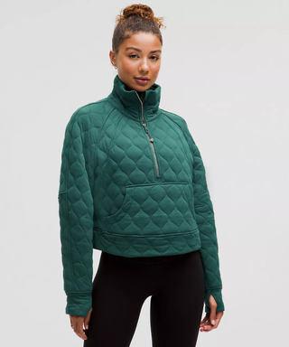 Female model wears green quilted jacket