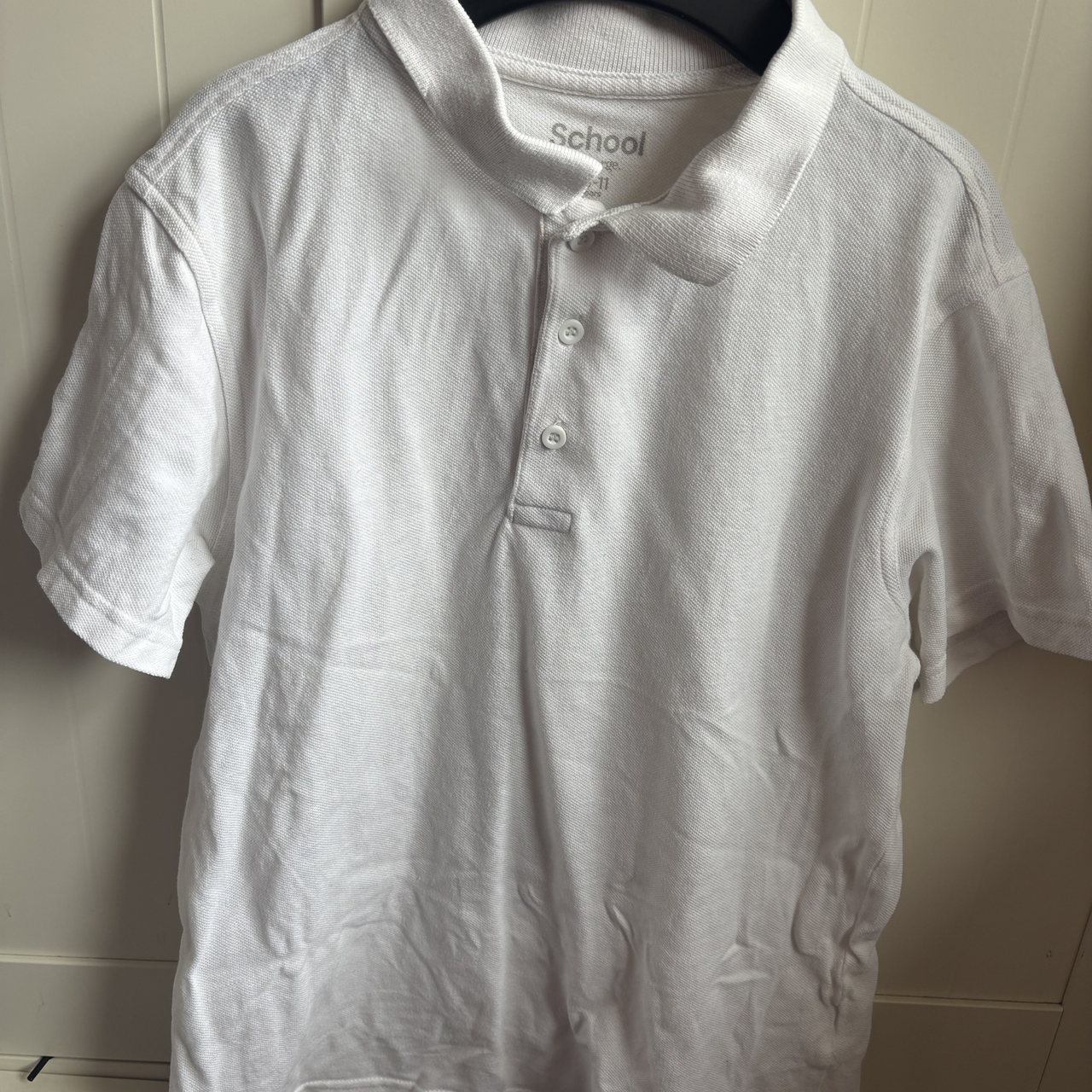 White polo shirt before using the Beldray Digital Handheld Steam Cleaner