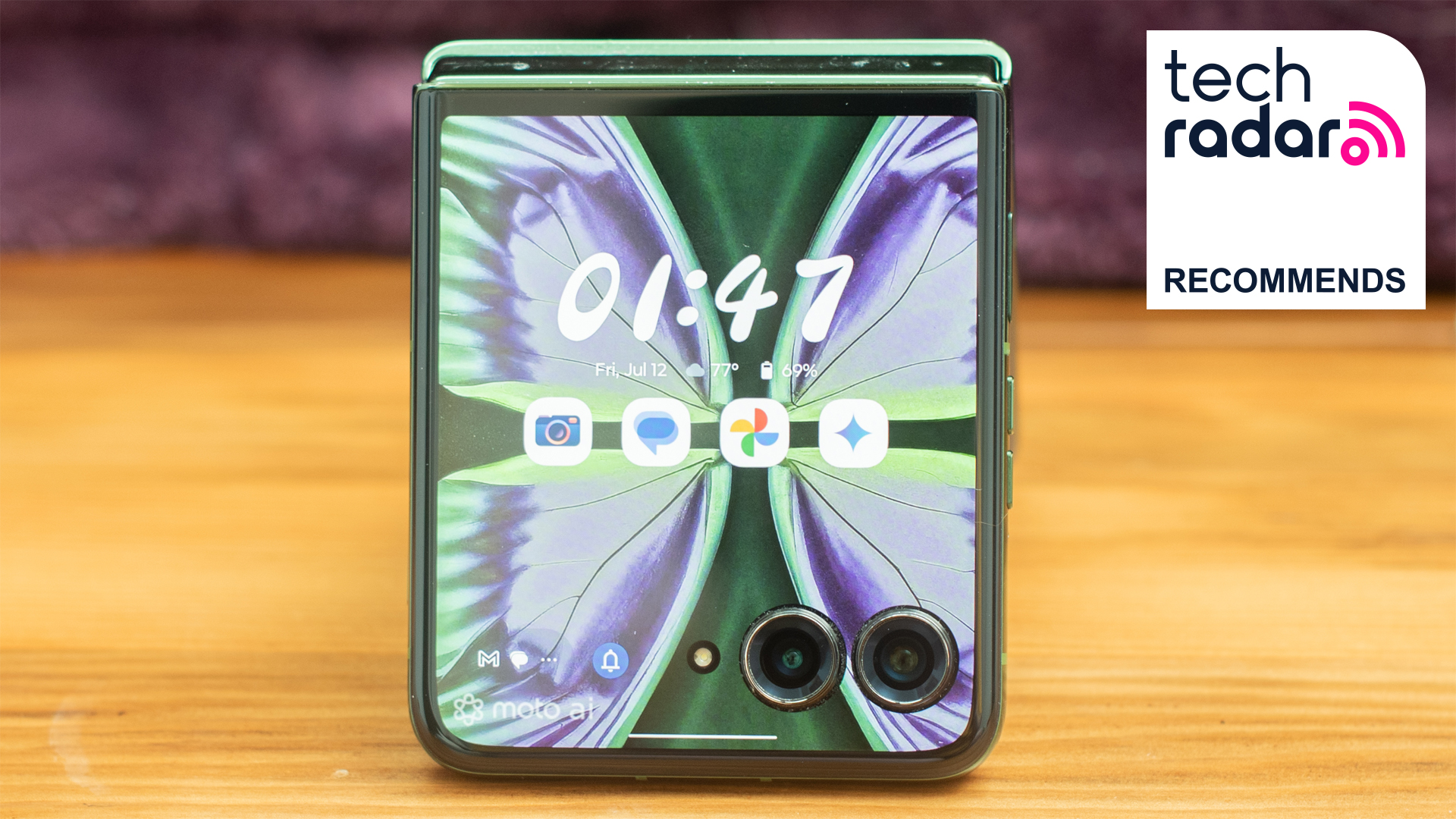 Motorola Razr Plus 2024 in green showing cover display with TechRadar Recommends badge