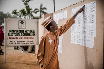 A man checks his name in voting lists at the State INEC Independent Electoral Comission Office in Jimeta, Nigeria, on February 16, 2019. 