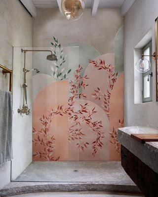 An example of bathroom art ideas showing waterproof pink floral wallpaper in a shower