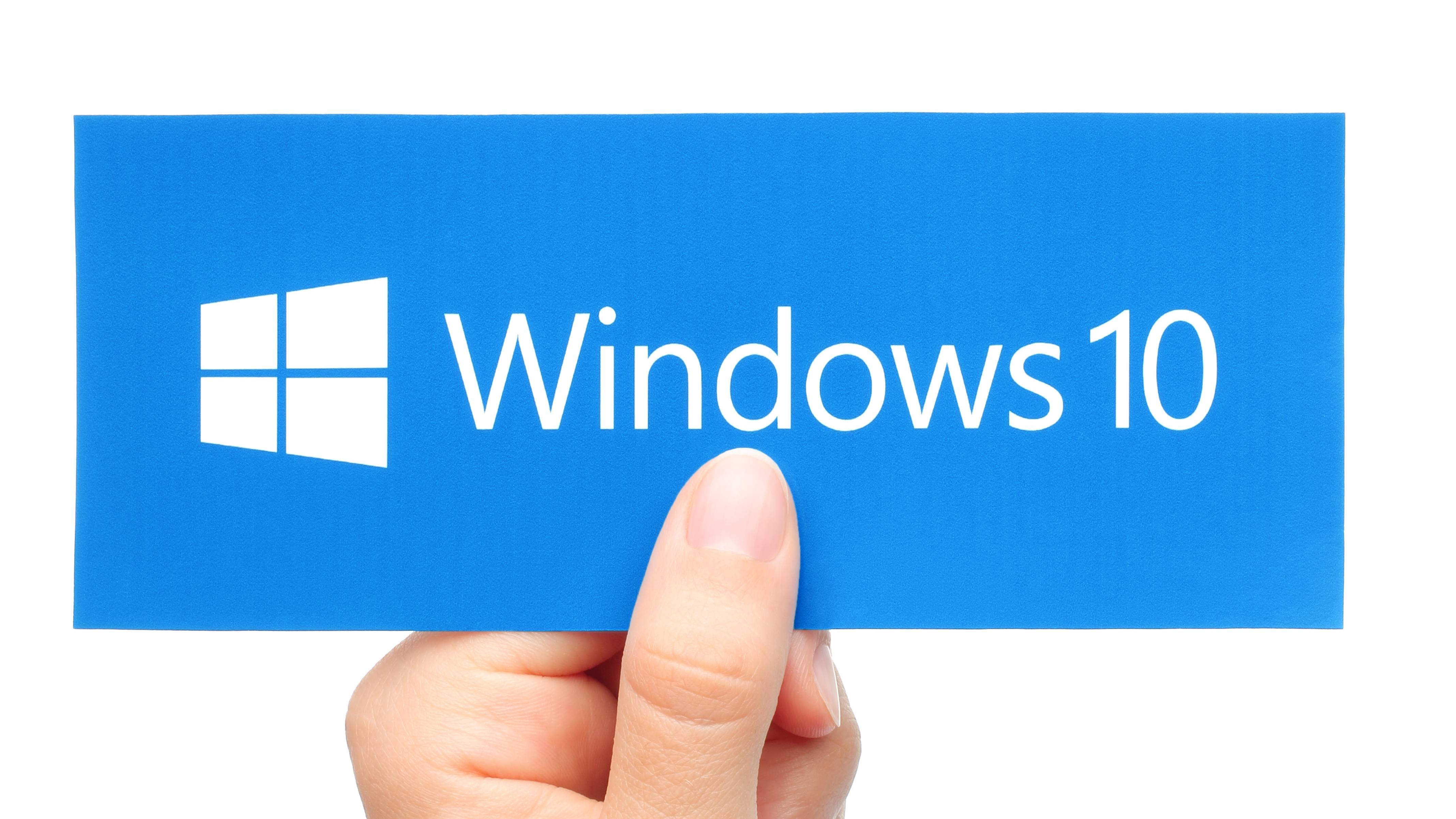 Windows 10 logo being held by thumb