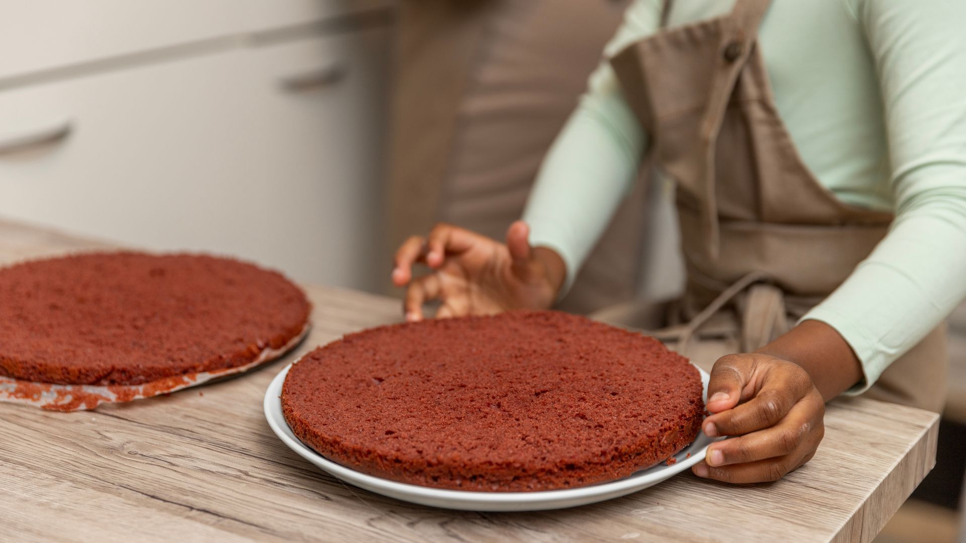 Woman baking two cakes