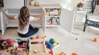 A woman clearing out the cupboards