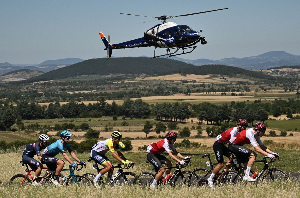 The pack of riders cycles during the 14th stage of the 109th edition of the Tour de France cycling race 1925 km between SaintEtienne and Mende in central France on July 16 2022 Photo by Marco BERTORELLO AFP Photo by MARCO BERTORELLOAFP via Getty Images
