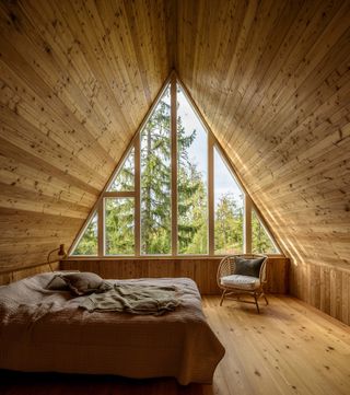 bedroom under timber pitched roof in a-frame house