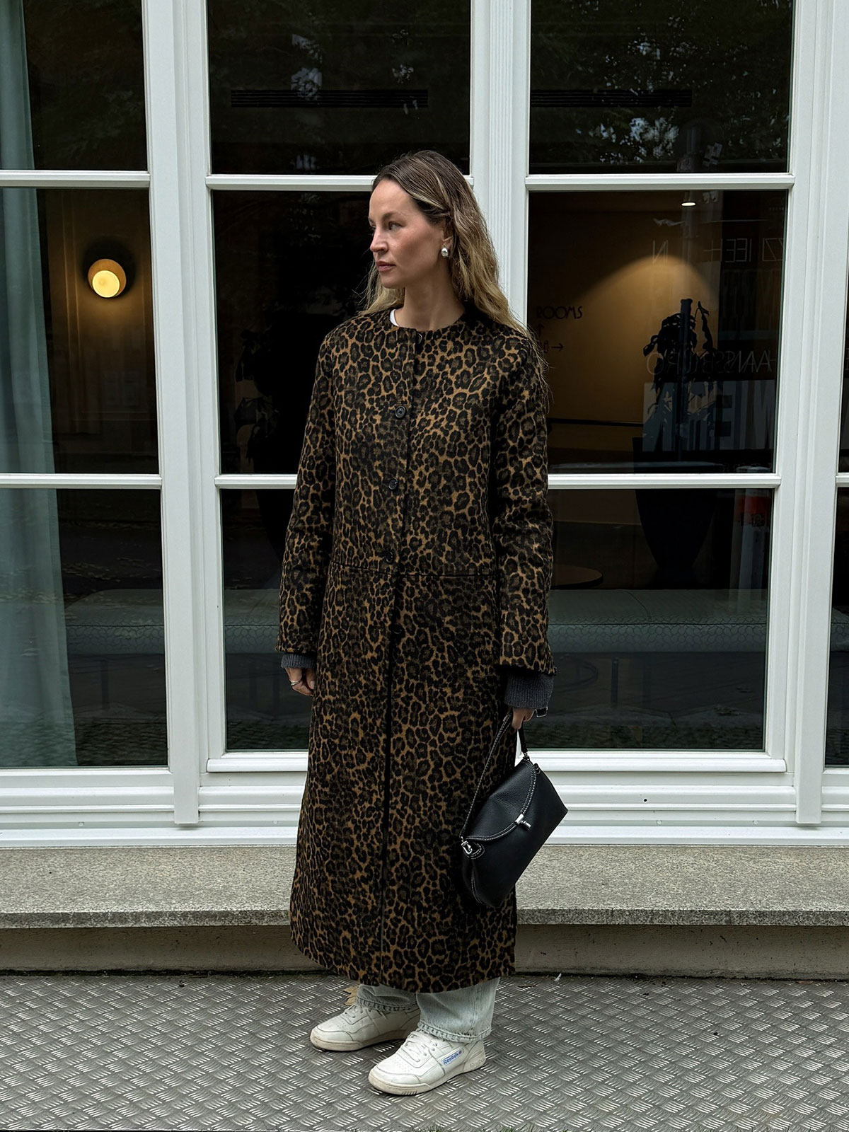Woman wearing the animal-print coat trend of fall/winter 2025.
