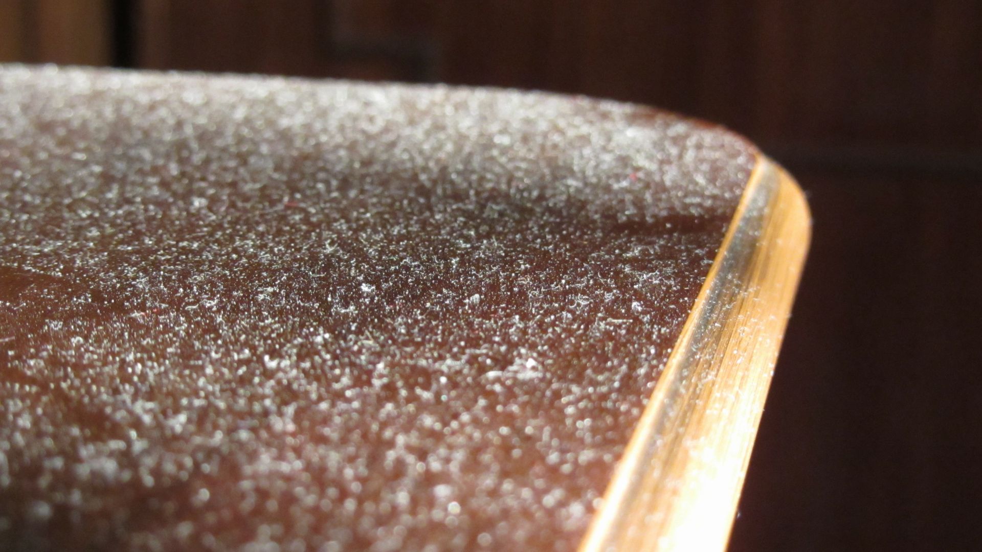 picture of dust on wooden table in home