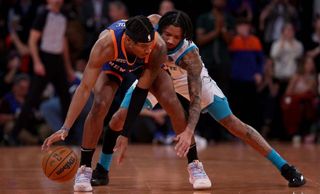 Miles McBride #2 of the New York Knicks runs out the clock as Nick Smith Jr. #8 of the Charlotte Hornets defends during the second half of an NBA In-Season Tournament game at Madison Square Garden on November 28, 2023