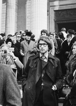 Yves Saint Laurent leaving Coco Chanel's funeral