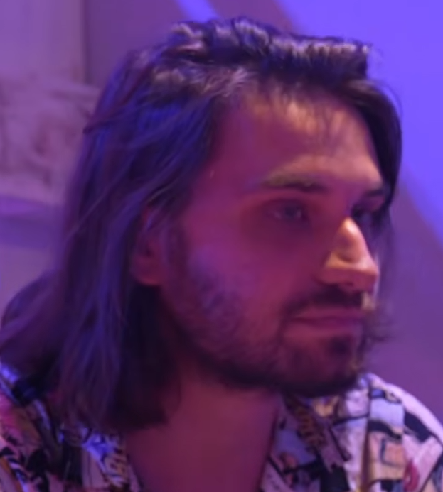 Summer Eternal operations director Aleksandar Gavrilović under purple lighting in video interview.