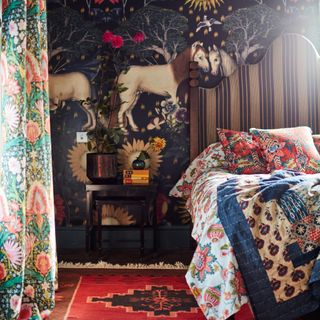 tiny guest room ideas, guest room with multiple prints and pattern, vintage rug, bold wallpaper, side table, mixture of prints on bedding