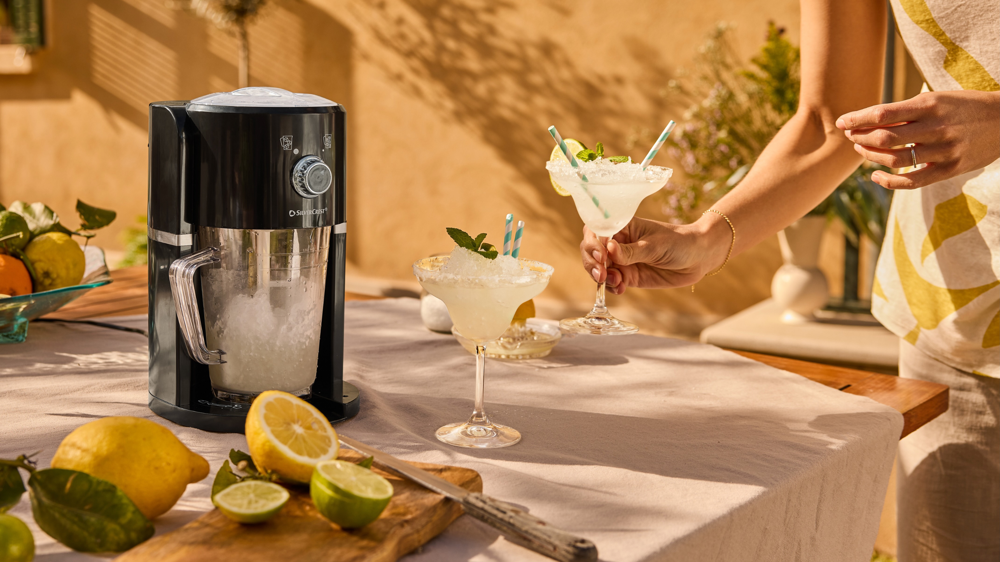 Lidl slushy maker next to frozen marg on outdoor table.
