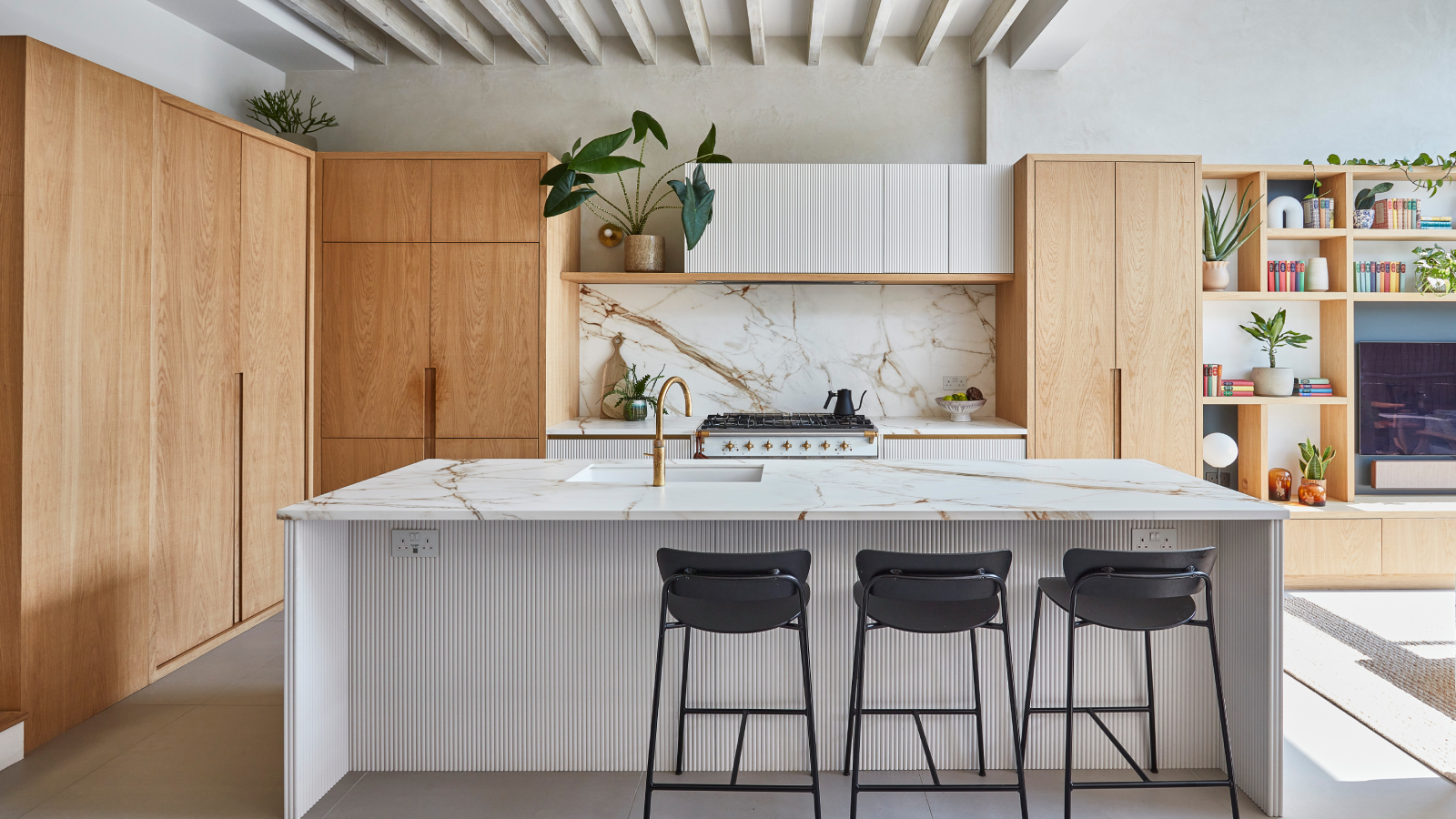 open plan kitchen extension with wooden scandi style units and large marble topped kitchen island