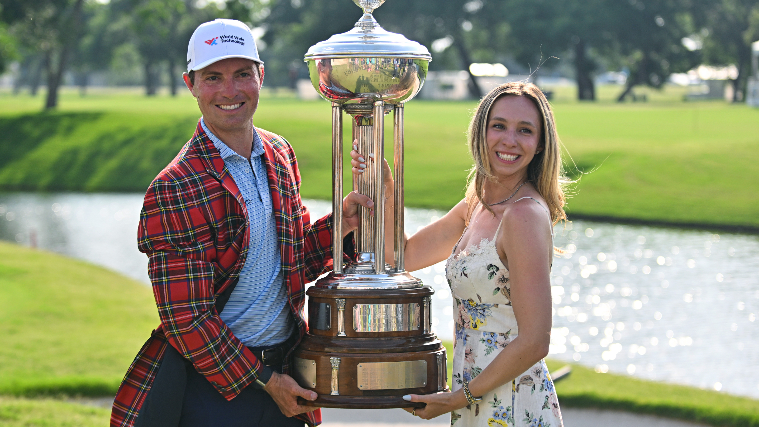 Ben Griffin and Dana Myeroff pose for a photo with the Charles Schwab Challenge trophy 