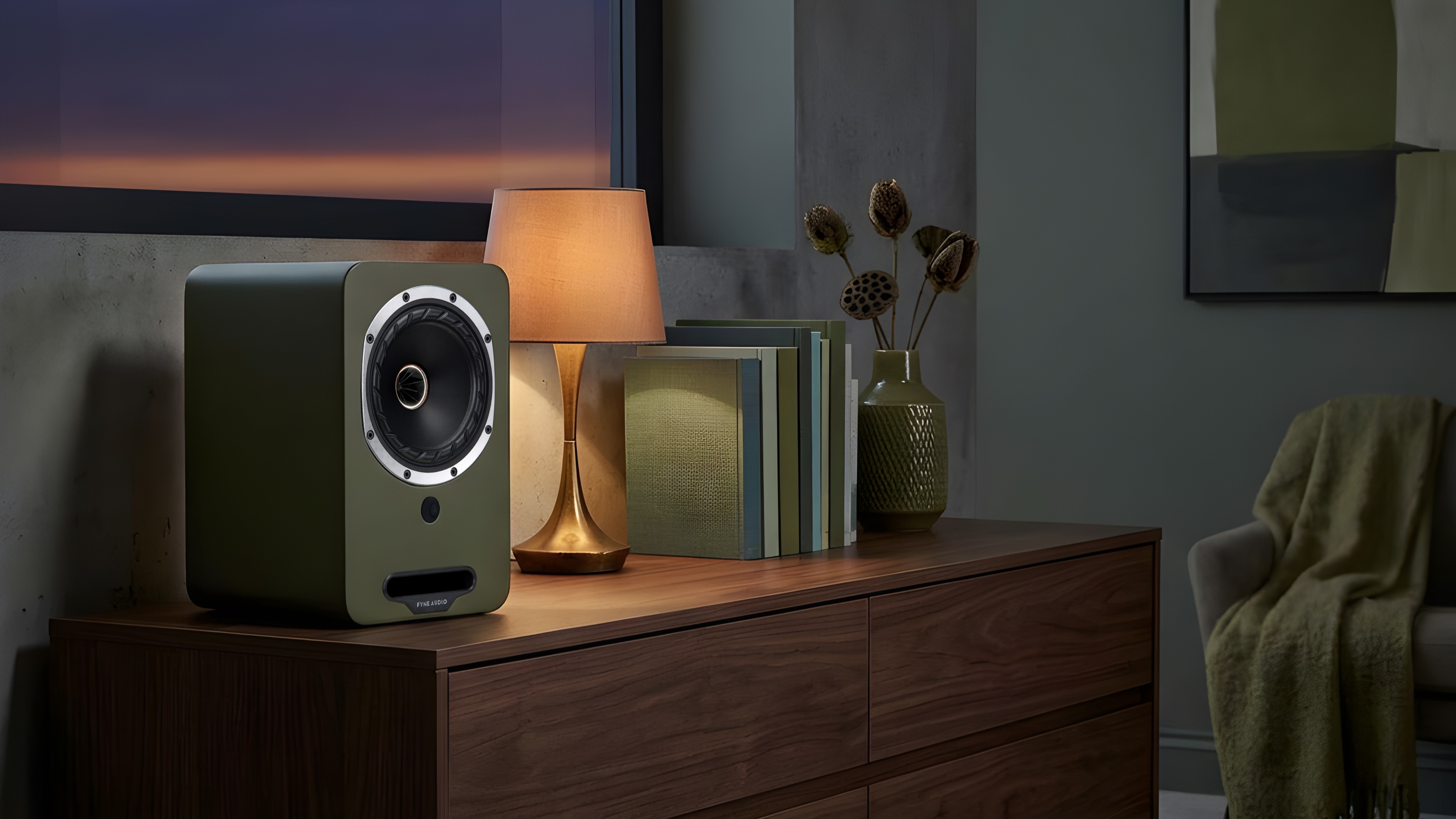 Fyne Audio Cubitt wireless speaker system in olive on a sideboard