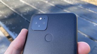 A Google Pixel 5 from the back, in someone's hand