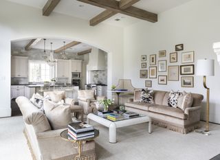farmhouse living room with sofas, coffee table and gallery picture display on wall